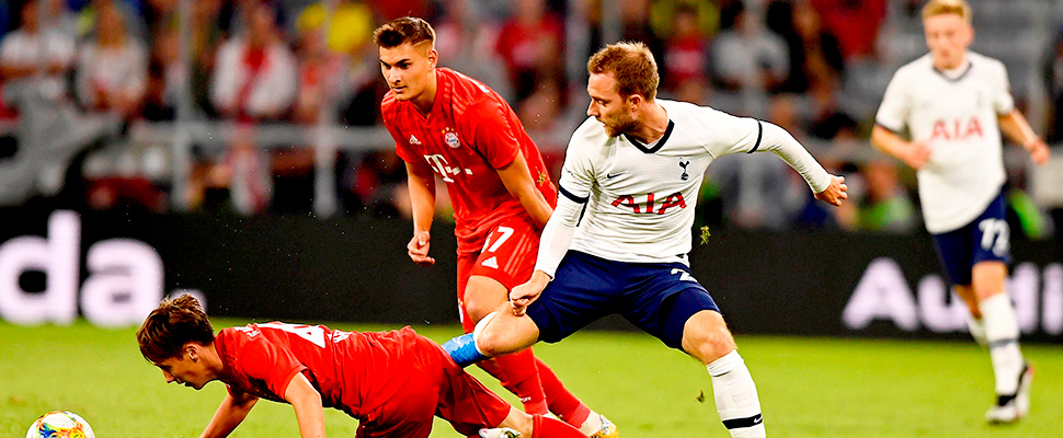 Bayern Munich's Jonas Kehl (L) in action against Tottenham's Christian Eriksen (R) during the Audi Cup final in Munich