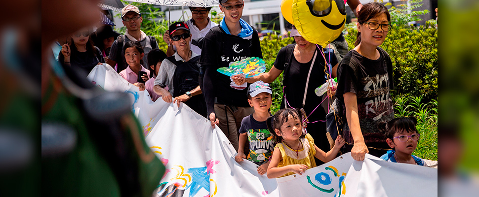 Demonstrators hold a banner during a march themed 'Guard Our Children's Future' in Hong Kong, China