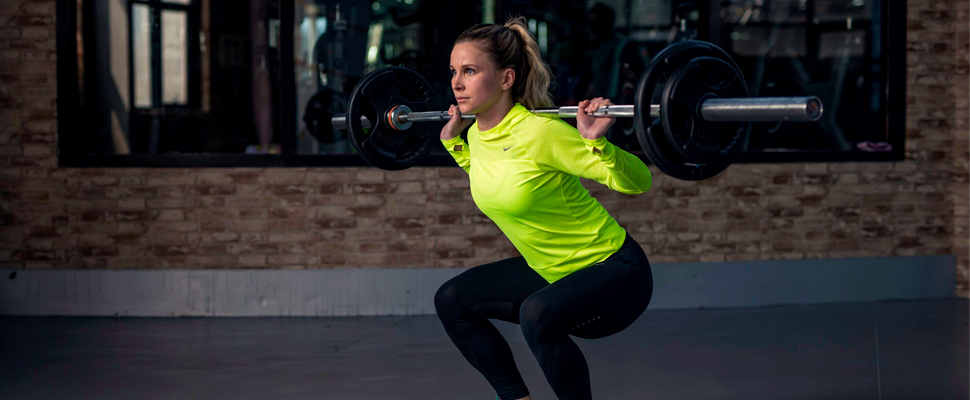 Woman lifting weights in the gym.