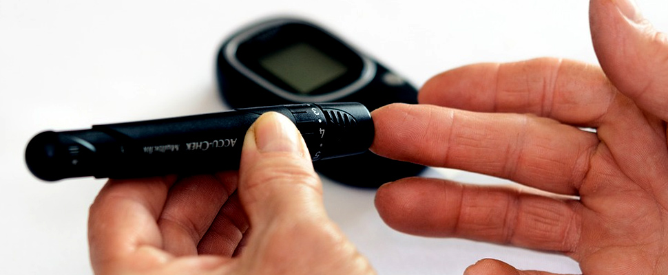 Person checking blood sugar level with glucometer