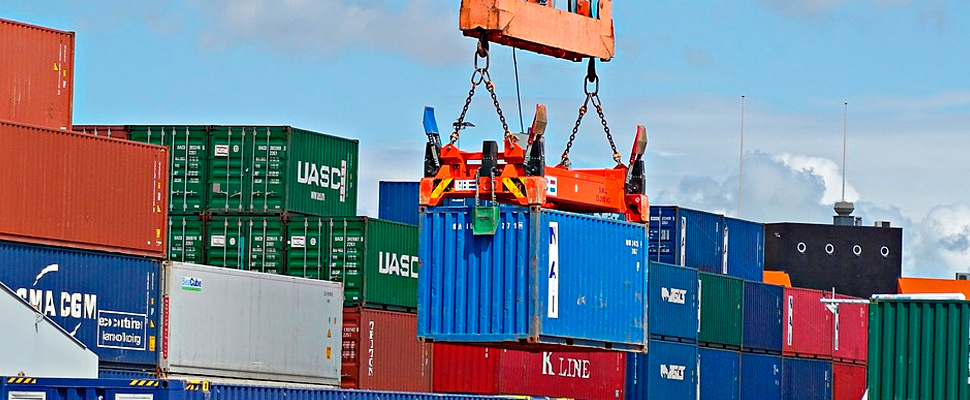 Container being lifted by a crane in a port