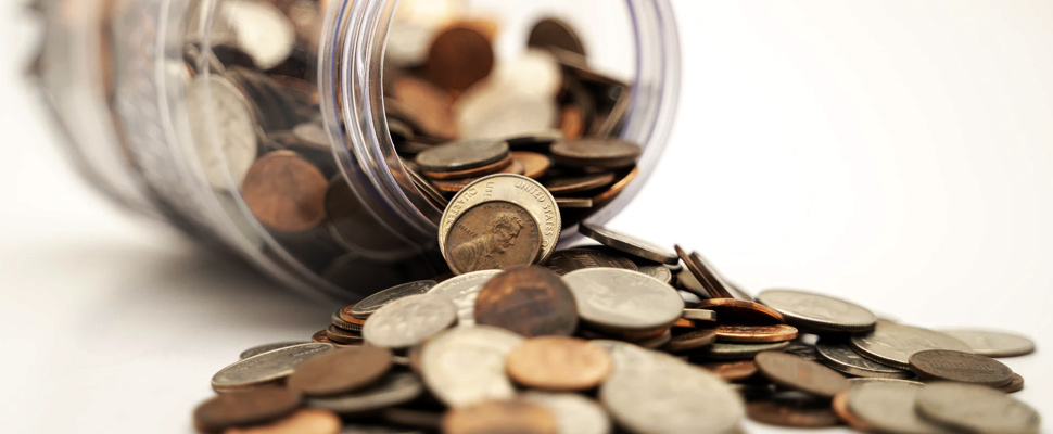 Coins pouring out of a jar