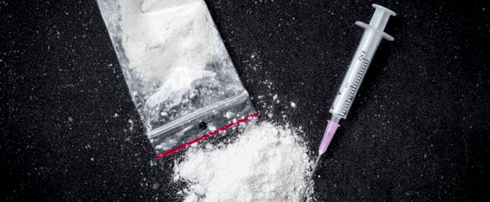 Bag of cocaine and a syringe.