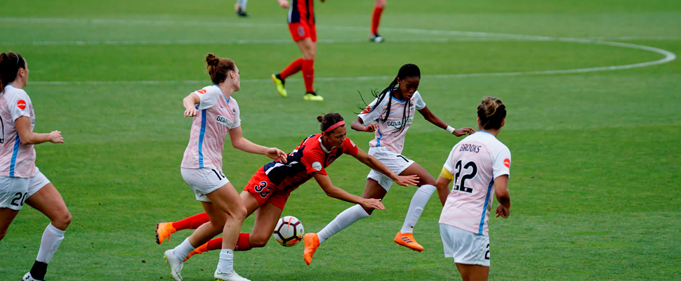 Woman playing soccer on field