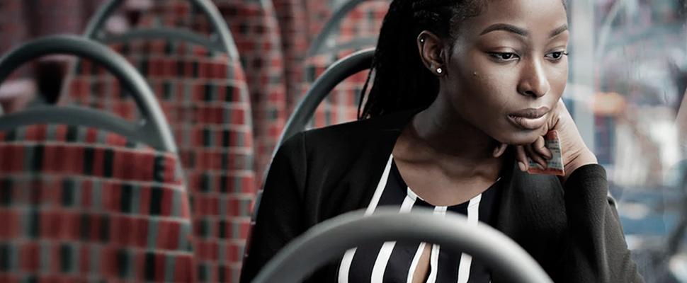 Woman looking out the window of a bus.