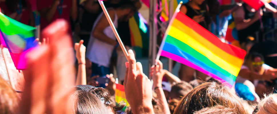 People holding rainbow flag.