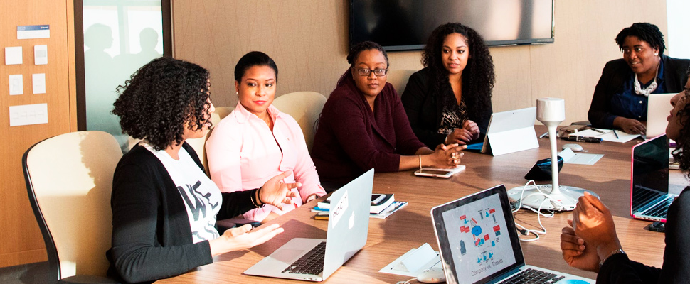 Group of woman sitting around the table.