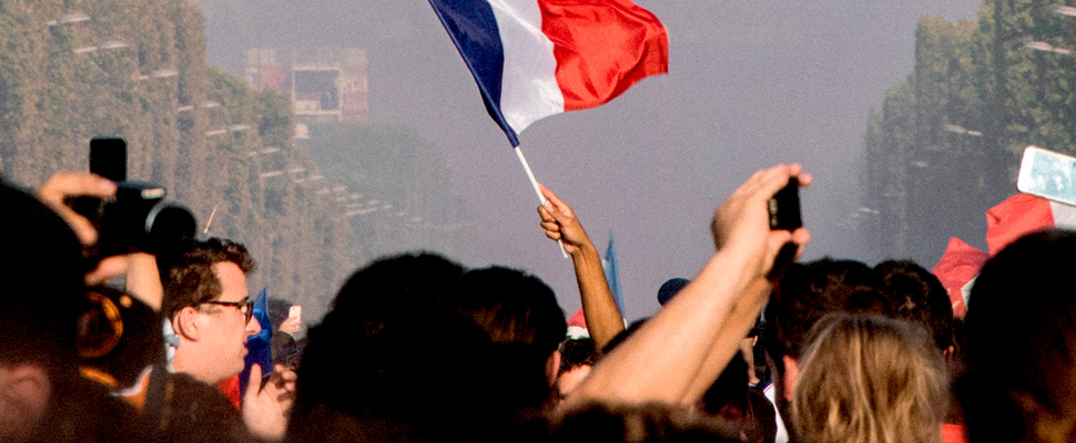 Person holding the flag of France during protests.