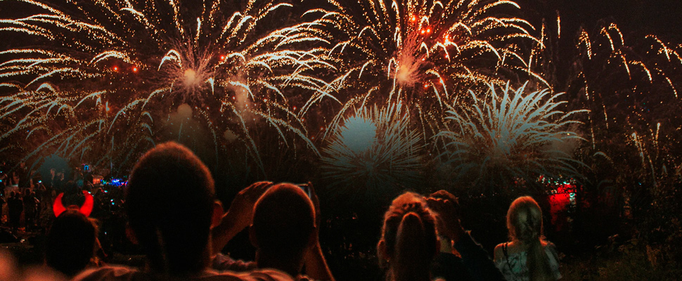 Group of people watching fireworks.