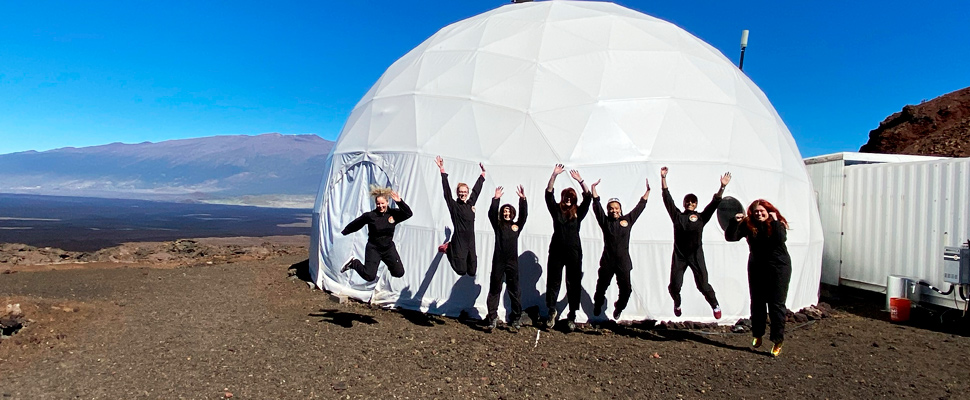 The Sensoria crew jumps for joy before entering the mock Martian habitat on Jan. 4, 2020.