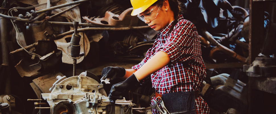 Woman engineer checking parts of a vehicle.