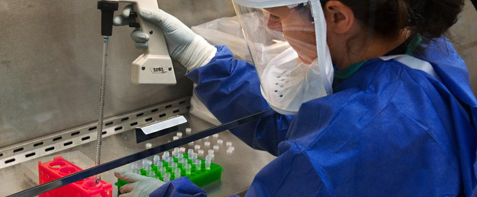 Woman performing tests in a laboratory.