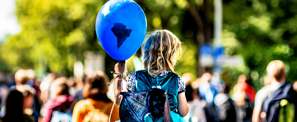 Girl holding a balloon with map drawn into it.