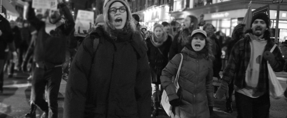 Group of people in the middle of a protest.