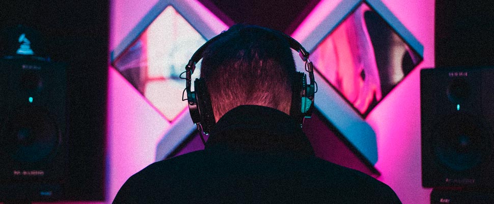 Man in a recording studio wearing headphones.