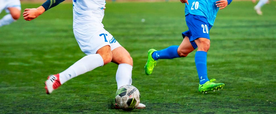 Two men playing soccer.