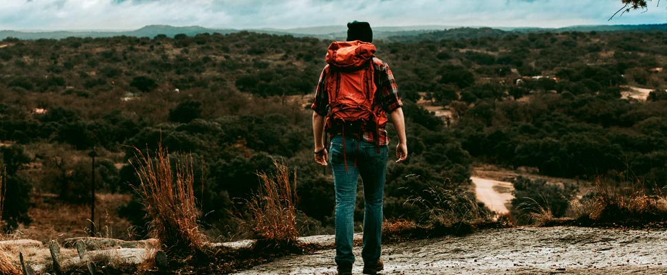 Woman standing on a natural area trail.