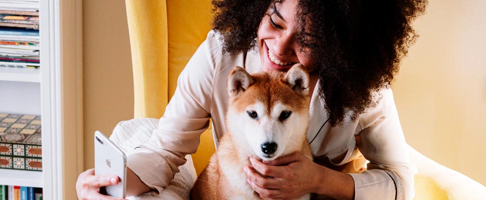 Woman taking a selfie with her dog.