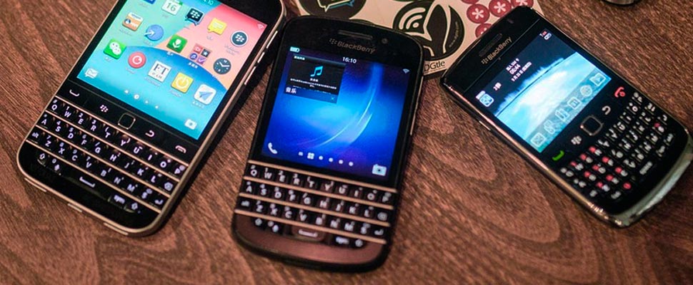 Three cell phones of the 'BlackBerry' brand.