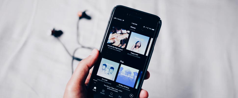 Person holding a phone while using the Spotify app