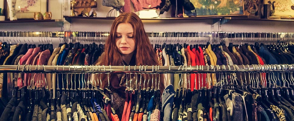 Woman checking clothes on a rack