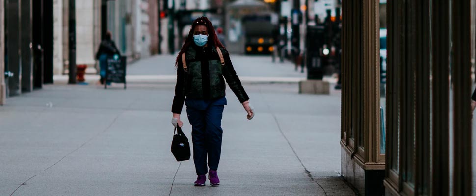 Woman wearing a face mask walking in the street