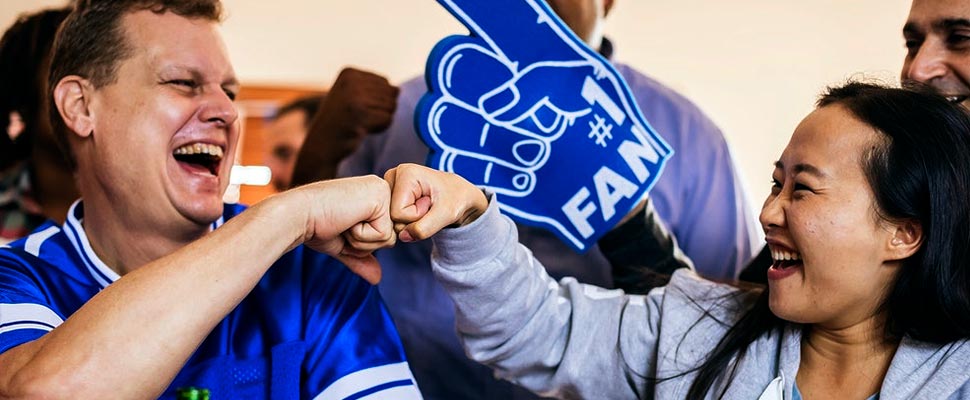 Fans bumping fists during a celebration