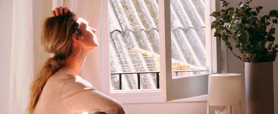 Woman sunbathing through a window.