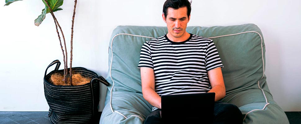 Seated man working on his computer