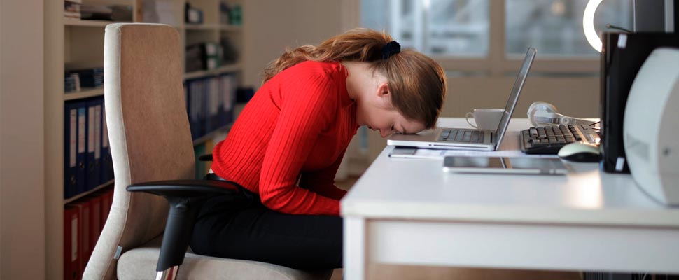 Woman leaning on her desk