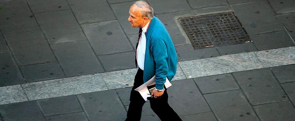 Older man walking down a street