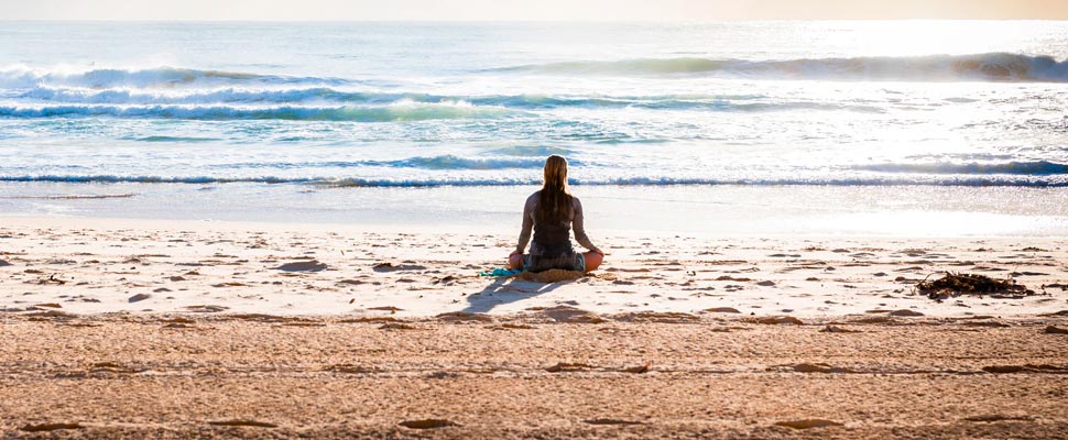 Woman sitting on the seashore