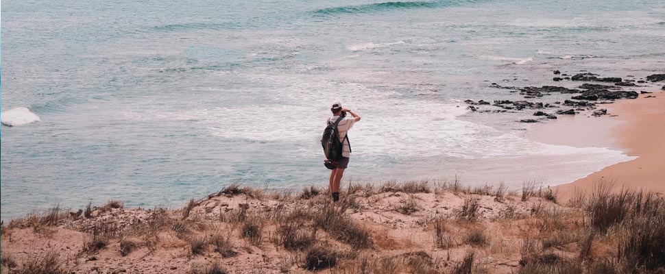 Person taking photos on the seashore