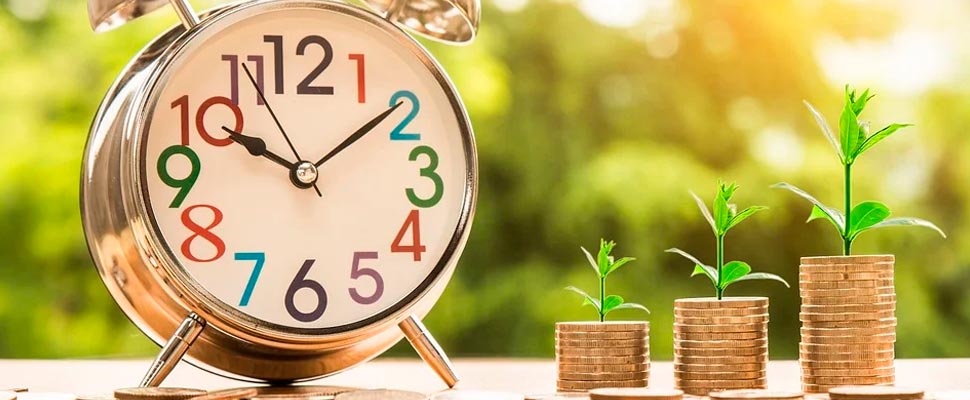 Clock next to some coins