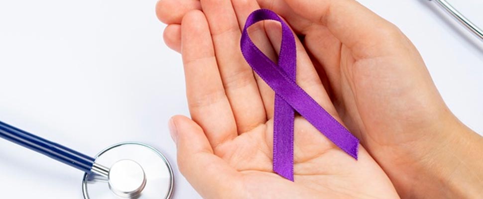 Hands holding a purple ribbon cancer symbol