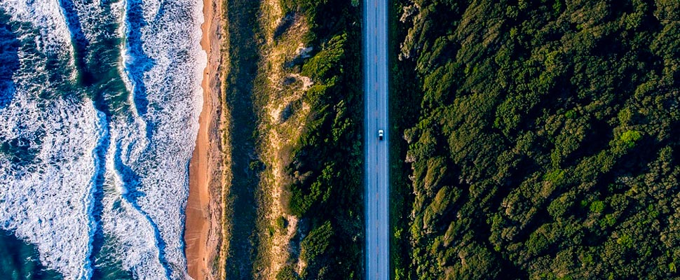 Aerial view of the seashore and a road