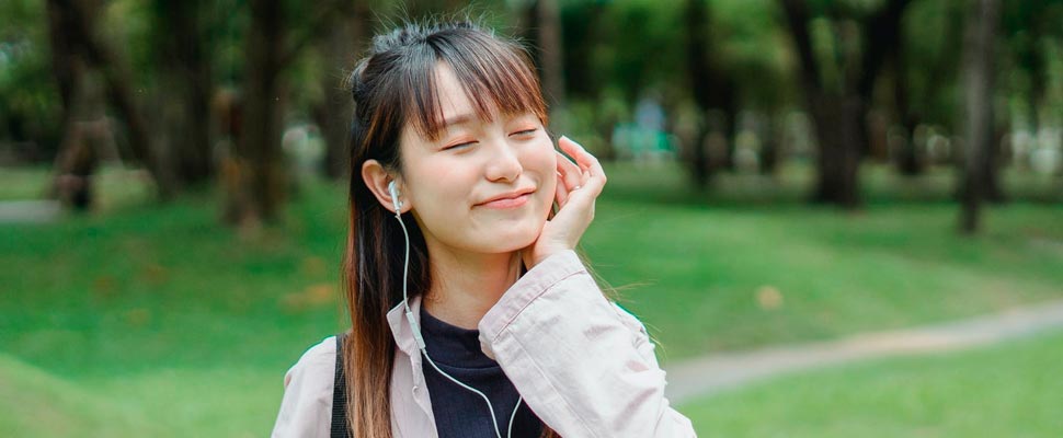 Woman listening to music wearing headphones