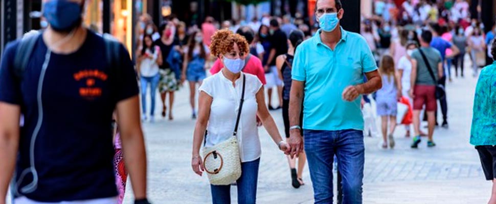 People walking down the street wearing face masks