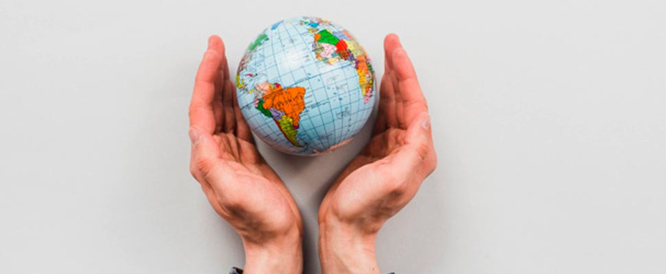 Hands holding a globe figure