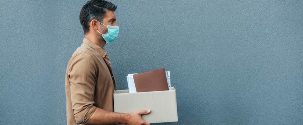 Man with mask carrying a box