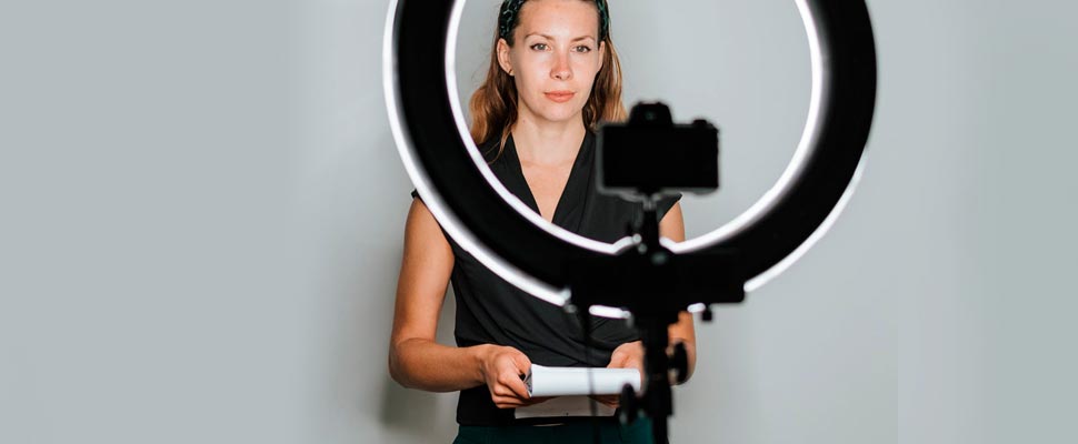 Woman making a recording holding a notepad