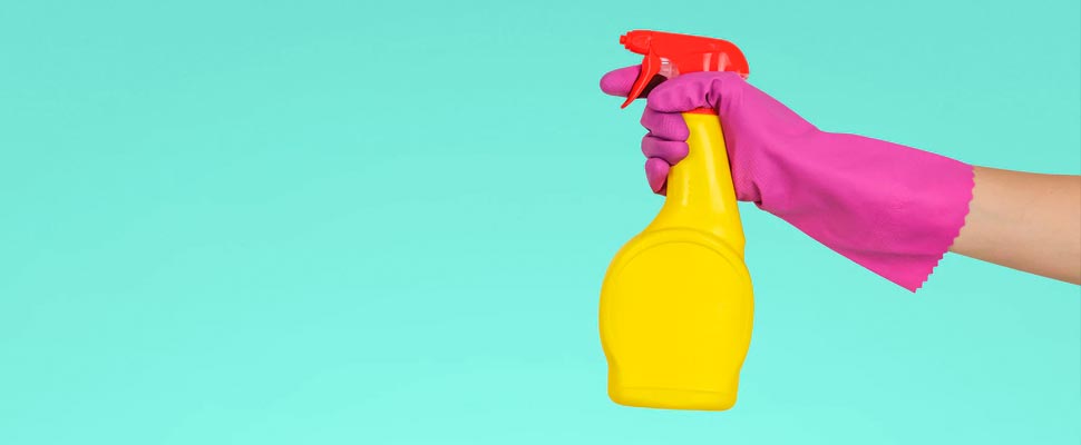 Person holding a bottle of cleaning product