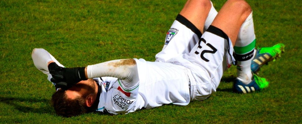 Footballer lying on the playing field