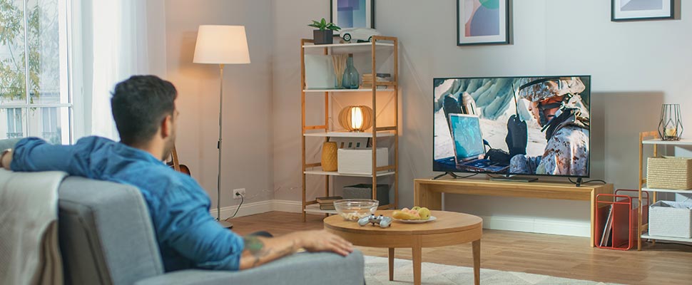 Man sitting on a sofa watching TV