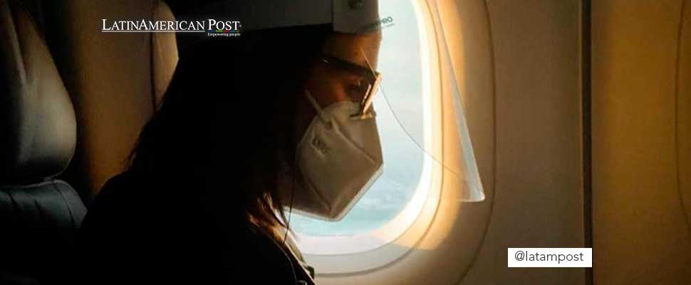 Woman wearing a face mask inside an airplane