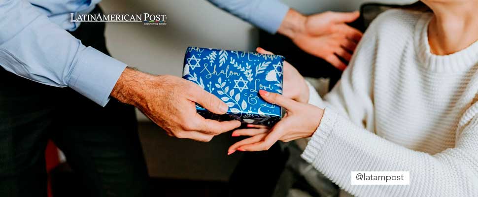 Two people holding a gift