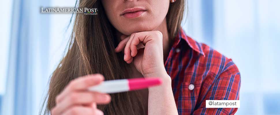 Woman holding a pregnancy test