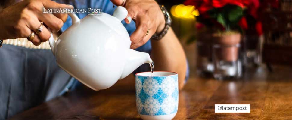 Woman serving a tea in a cup