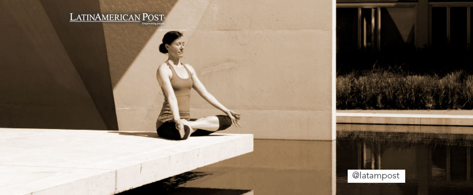 Woman doing yoga outside a building