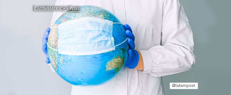 Person holding a world globe with a mask